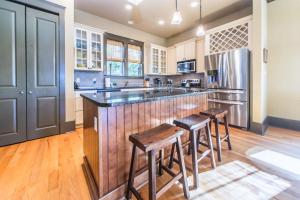 a kitchen with a center island with bar stools at Comfort and Joy in Seacrest