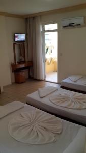 Postel nebo postele na pokoji v ubytování Caner Hotel