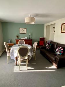 uma sala de estar com uma mesa e cadeiras e um sofá em l'ANNEXE em Verdigny