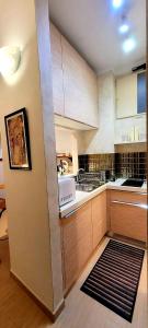 a large kitchen with wooden cabinets and a sink at appartamento pontevecchio in Florence +7 photos