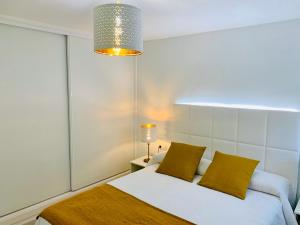 a bedroom with a bed and a chandelier at Marina in Tías