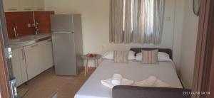a small room with a bed with towels on it at lemonishouse by the sea 1 in Nea Skioni