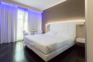 Postel nebo postele na pokoji v ubytování Raffaello Hotel & Mooka Restaurant
