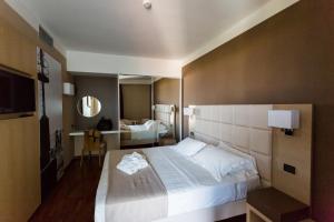 Postel nebo postele na pokoji v ubytování Raffaello Hotel & Mooka Restaurant