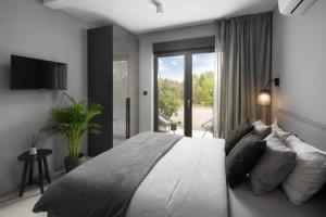 a bedroom with a large bed and a large window at Villa Anthea Paola in Nedeščina +31 photos