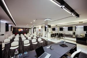 a conference room with a table and chairs and a laptop at Raffaello Hotel & Mooka Restaurant in Senigallia