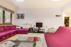 a living room with pink couches and a tv at 34 Yüksel Caddesi in Ankara
