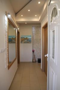 korytarz z białymi drzwiami i podłogą wyłożoną kafelkami w obiekcie Davidoff Branko Kalezic w Budvie