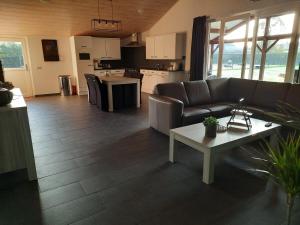 a living room with a couch and a table at 't Brugske in Deurne