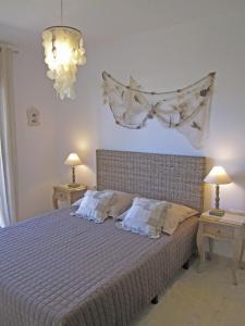 a bedroom with a bed with two tables and two lamps at La Tarongina apartament amb piscina in Llança