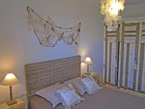 a bedroom with a bed with white pillows on it at La Tarongina apartament amb piscina in Llança +28 photos