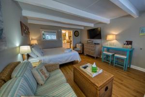 a hotel room with a bed and a living room at Waterway View Studio 2 w/ Pool, 1 mile to Wrightsville Beach in Wilmington