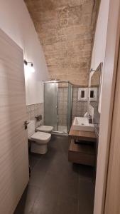 La salle de bains est pourvue de toilettes, d'un lavabo et d'une douche. dans l'établissement Casa Vittoria, à Palazzolo Acreide