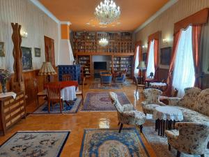 a living room filled with furniture and a chandelier at Fábiánics Kastély Misefa in Misefa