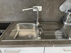 a stainless steel sink with a faucet in a kitchen at Ferienhaus Hopfental in Kelheim +41 photos