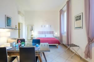 a bedroom with a bed and a table and chairs at Residenza Ariosto by Studio Vita in Bologna