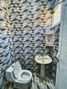 a bathroom with a toilet and a sink at Atiaf Jabal Shams house in Misfāh