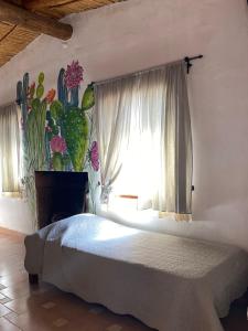 a bedroom with a bed and a large window at Cactus y Almacen - Purmamarca in Purmamarca