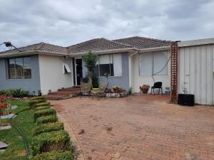 a house with a brick patio in front of it at Entire 3 bed rooms unit -Rosy house 1 in Noble Park