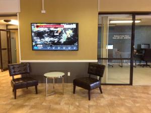 a waiting room with two chairs and a tv on the wall at Baymont by Wyndham Salem Roanoke Area in Salem