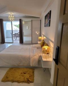 a bedroom with a large bed and a view of a balcony at Hello Guyane (4), Suite Junior Luxury, 5 étoiles in Cayenne