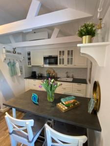 a kitchen with a table and two chairs at Carpe Diem Guest Cottage in Östhammar