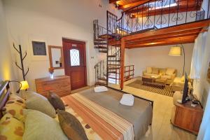 a bedroom with a loft bed and a living room at Plokamos House in Plokamianá