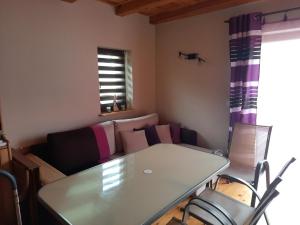 a living room with a table and a couch at Wycinki domek in Osiek