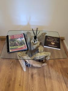 two books on a glass table on a wooden floor at Ferienwohnung Sonnenhaus in Wonsees