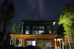 a house under the milky way at night at Stone Cove Waterfront Adults Only B&B in Tobermory