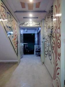 a hallway with graffiti on the walls of a room at Entire Furnished Two bedrooms Apartment Ground Floor with kitchen in Karachi