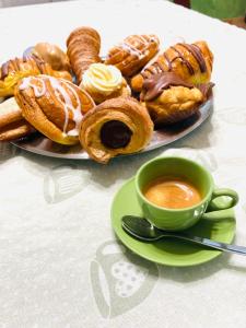 a plate of pastries and a cup of coffee on a table at B&B Villa Sabrina in Arezzo