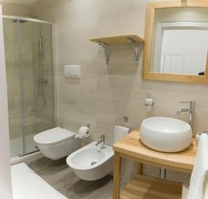 a bathroom with a sink and a toilet and a shower at Alicam in Uggiano la Chiesa