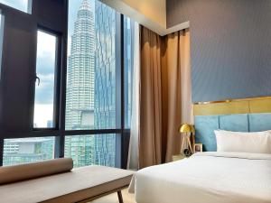 a hotel room with two beds and a large window at Star at KLCC in Kuala Lumpur