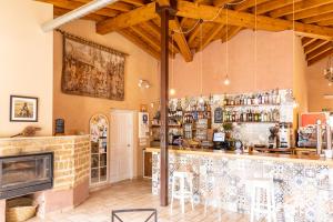 a restaurant with a bar and a fireplace at Albergue LaMorena in Ledigos