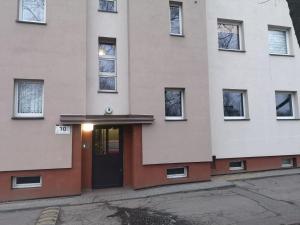 a building with a door in front of it at Apertament KOSMOS in Zabrze