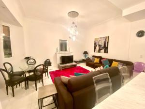 a living room with a couch and a table at High-End Apartment, Hyper Center, Near The Beaches in Nice