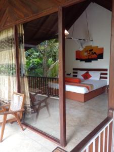 a bedroom with a bed and a balcony at Liyana Holiday resort in Anuradhapura