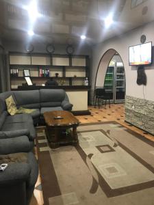 a living room with two couches and a table at Hotel ERA in Tbilisi City