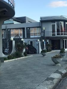 a building with a car parked in front of it at Hotel ERA in Tbilisi City