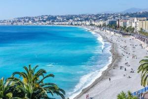 a beach with palm trees and people on it at High-End Apartment, Hyper Center, Near The Beaches in Nice