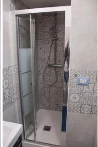 a shower with a glass door in a bathroom at Posidonia in Porticello