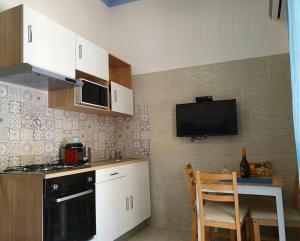 a small kitchen with a table and a microwave at Posidonia in Porticello