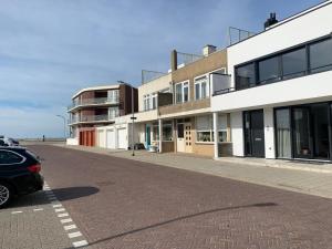 a car parked on a street next to a building at Strand & meer in Katwijk