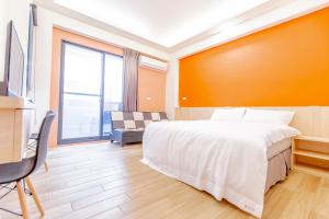 Ένα ή περισσότερα κρεβάτια σε δωμάτιο στο WOW Penghu Homestay