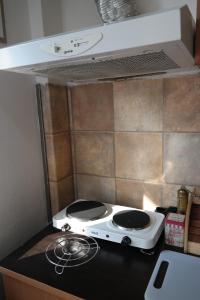 a stove top oven in a small kitchen at E-19 Home - Tradition meets tourism in Prizren
