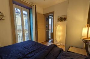 ein Schlafzimmer mit einem blauen Bett und einem Fenster in der Unterkunft Appartement - City center in Montpellier