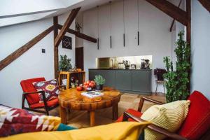 ein Wohnzimmer mit einem Tisch und Stühlen sowie eine Küche in der Unterkunft HAPPY MOMENTS APARTMENTS in Krakau