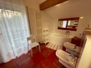 a bathroom with a tub and a toilet and a sink at Apartamenty Czyrna przy Gondoli in Szczyrk