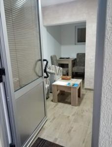 a living room with a couch and a table at Apartman Oreol in Priboj